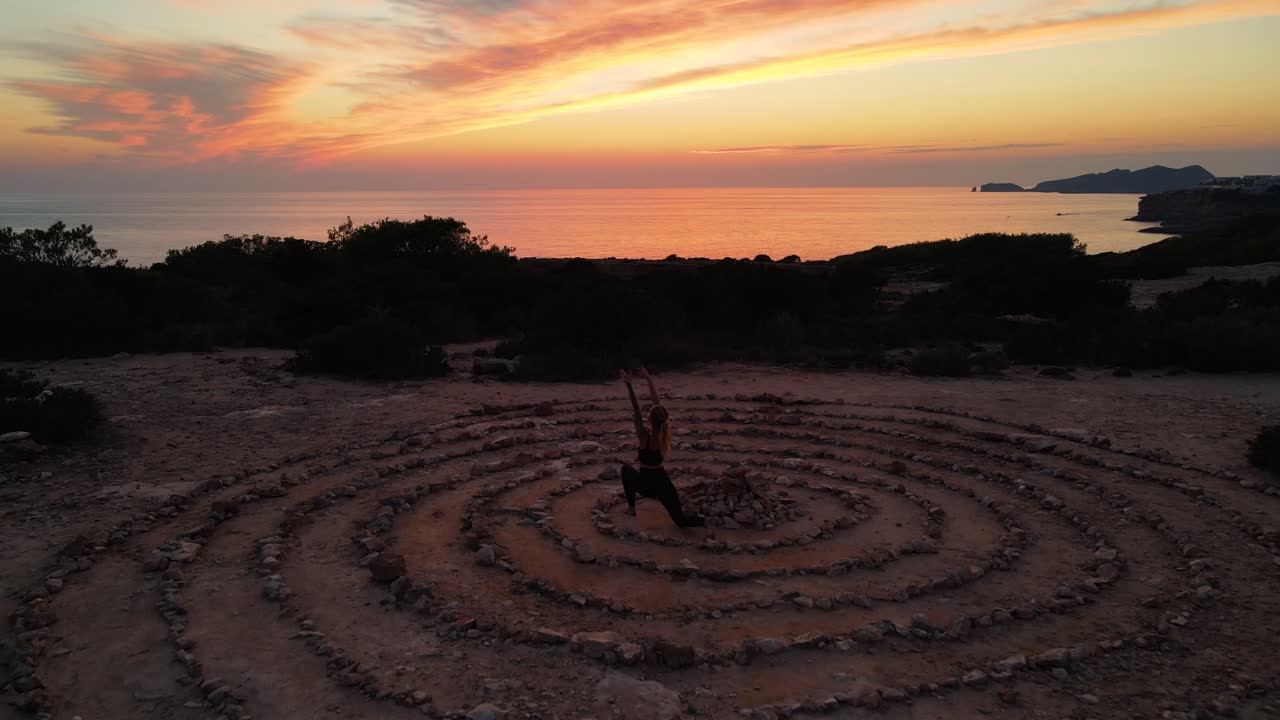 Woman doing some yoga during sunset at the time and space in Ibiza, Spain