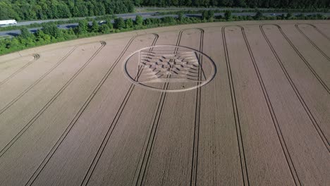 cinematic footage of crop circles in grain crop yellow field near the uk's micheldever station