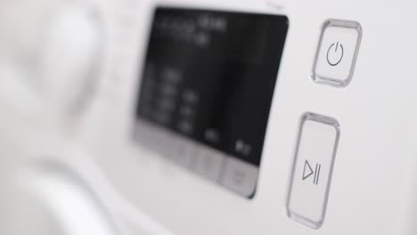 setting the program panel of the washing machine for washing clothes setting the program panel of the washing machine for washing clothes washing machine display during washing close up