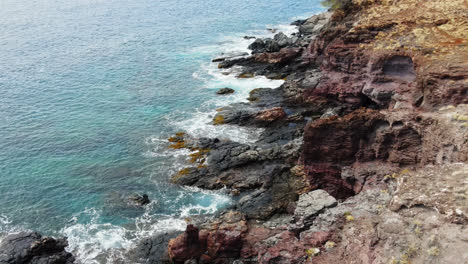 aerial drone of the west mountain shoreline in maui, hawaii