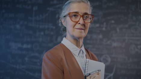 teacher in front of a chalkboard
