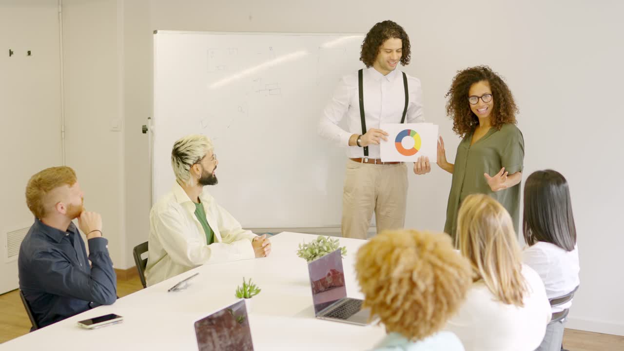Woman using graphic during a presentation in a meeting room
