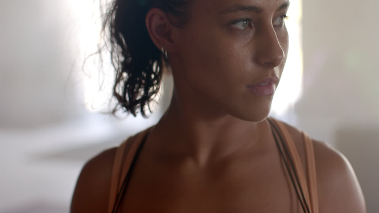 Exercising in gym, woman with ponytail focusing on workout routine