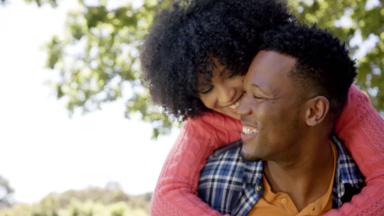 Happy african american man embracing in garden at home, slow motion