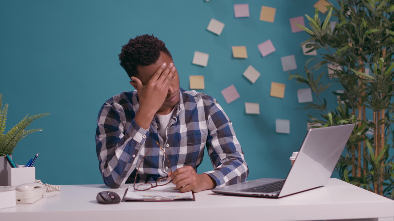 Stressed freelancer feeling tired about overtime work on laptop