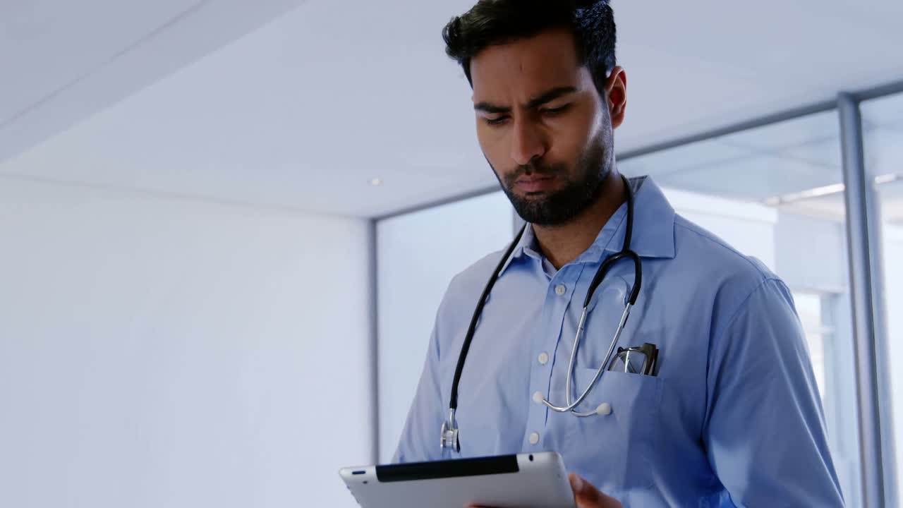 Male doctor using digital tablet