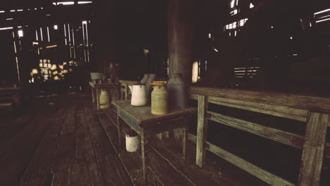 rustic interior of an old barn showcasing vintage pottery and wooden furniture