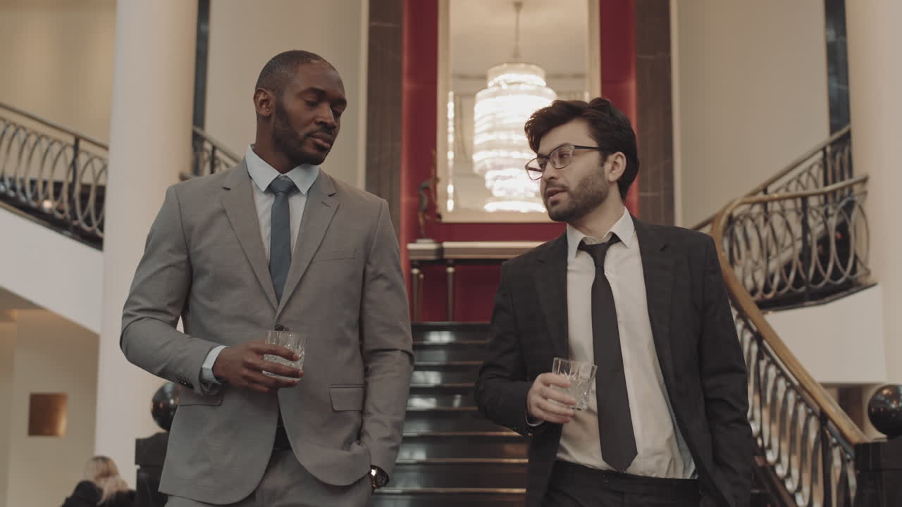 Successful Men with Whiskey Glass Walking