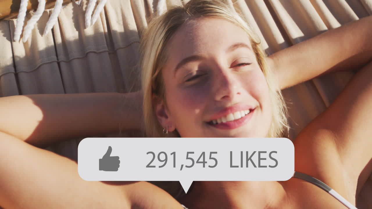 Relaxing on hammock, woman with social media likes animation overlay