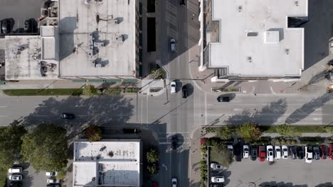 Holland,-Michigan-downtown-with-drone-video-overhead-at-an-intersection-with-traffic-moving