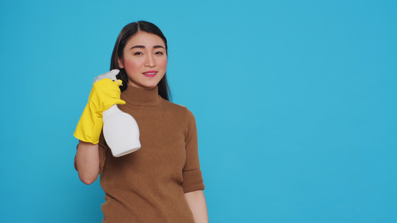 Cleaning woman pointing and showing cleaning product or isolated text