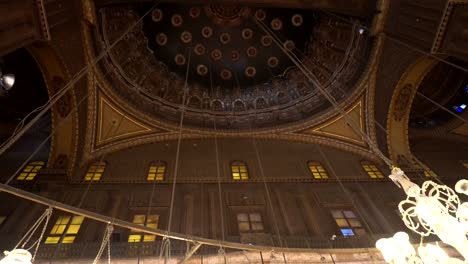 mosque of muhammad ali interior illuminated chandelier ceiling with painting of arab muslim in arch