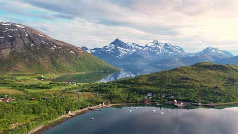 scenic road on the coast of northern norway with mountains, sea and settlement