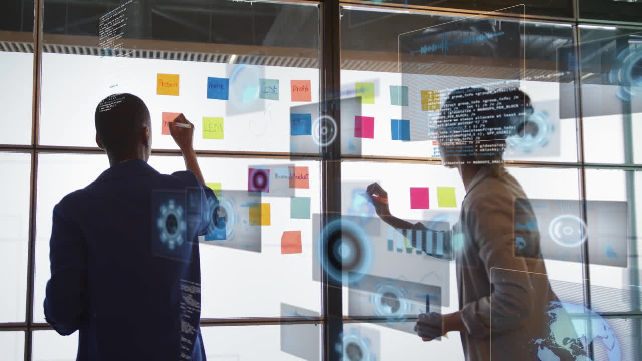 Collaborating on animation project, two people using colorful sticky notes in school