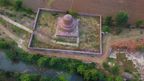 Top-down-Aerial-drone-shot-of-Ancient-Buddhist-Stupa-made-from-rock-brick-structure-in-a-village-of-Shivpuri-Madhya-Pradesh-in-India