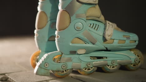 close-up side shot of rollerblades gently rolling in place against a nighttime background. the motion and texture of the skates, emphasizing the urban, nocturnal ambiance and active lifestyle