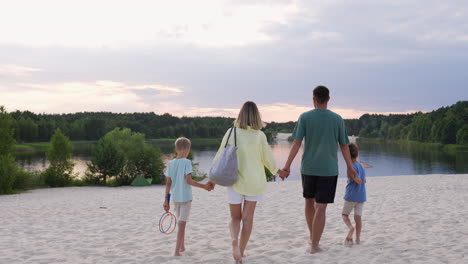 family holding hands on the beach