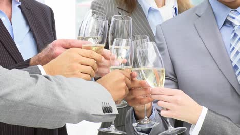 close up of business team toasting with champagne