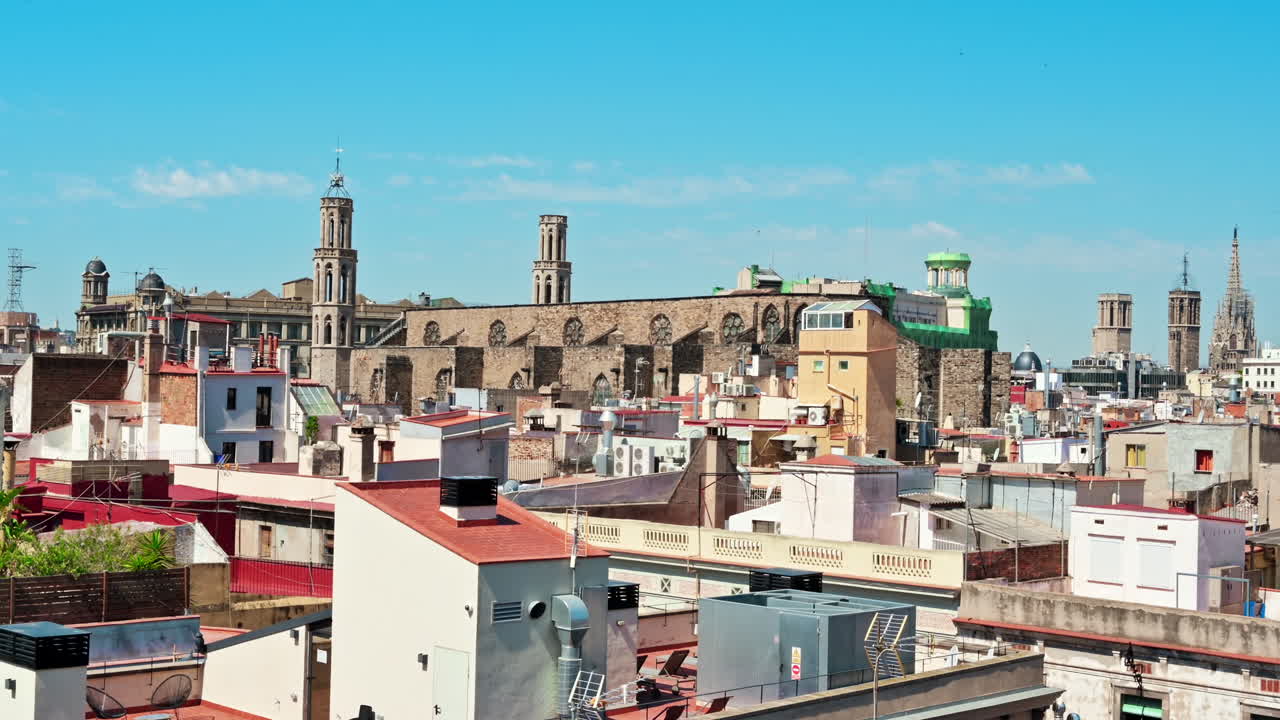 Panoramic view of Barcelona, multiple building's roofs, old cathedrals, Spain