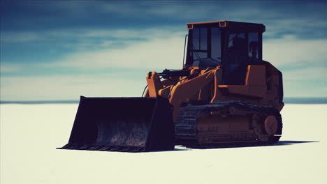 road grading machine on the salt desert road