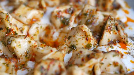 turkish manti dumplings with yogurt and red pepper flakes