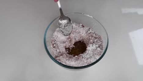 mixing cocoa and icing sugar with butter and water