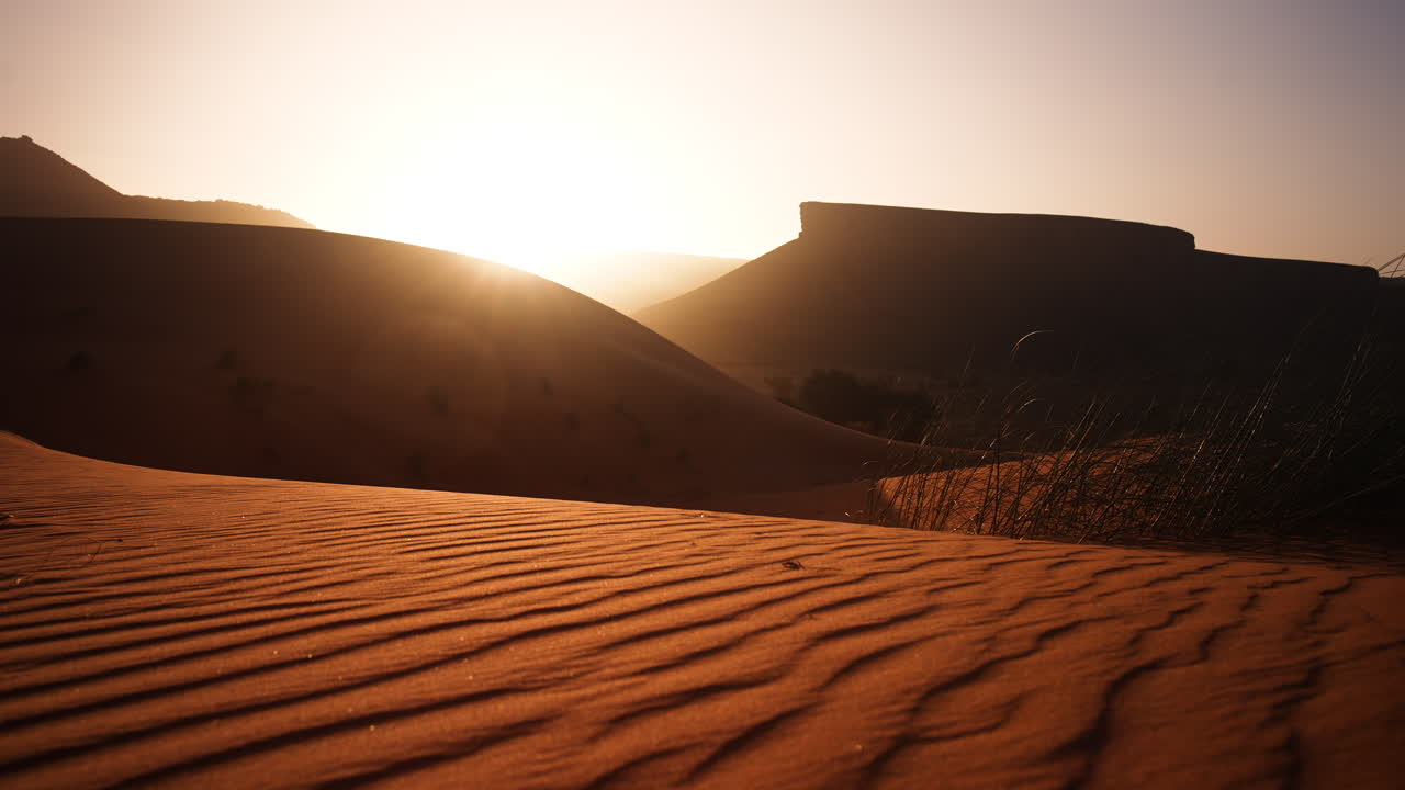 Sunrise over Desert Dunes and Mountains