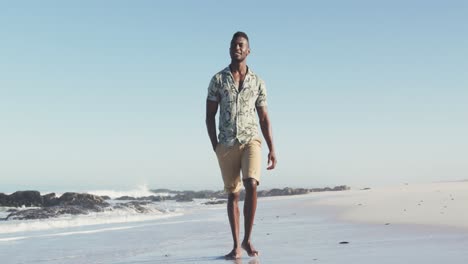 african american man walking seaside