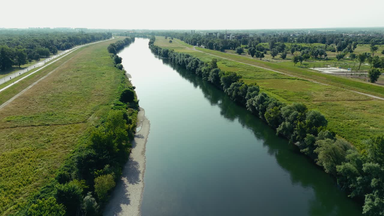 smooth green waters of the Sava flow past tree-lined banks and open fields near Zagreb