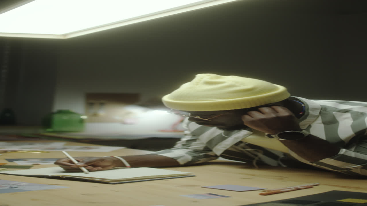 Artist Listening to Music and Drawing