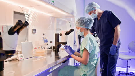 scientists working in a laboratory with microscopes