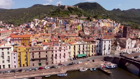 Explore-the-captivating-streets-and-architecture-of-Bosa,-Sardinia,-through-stunning-drone-footage