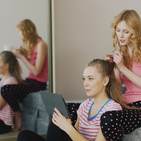 two young women paint the nails at home 5