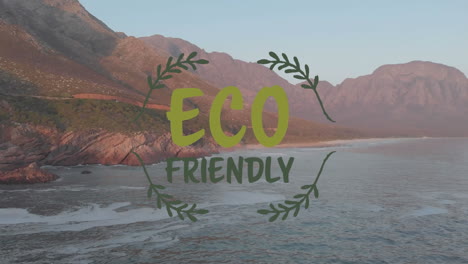 animation of eco friendly text over ocean's rocky coast