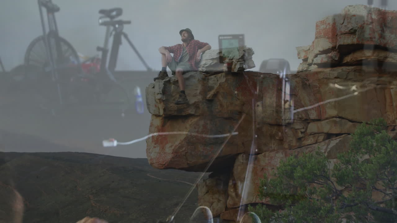 Sitting on rocky cliff, person with bicycle admiring landscape with animation