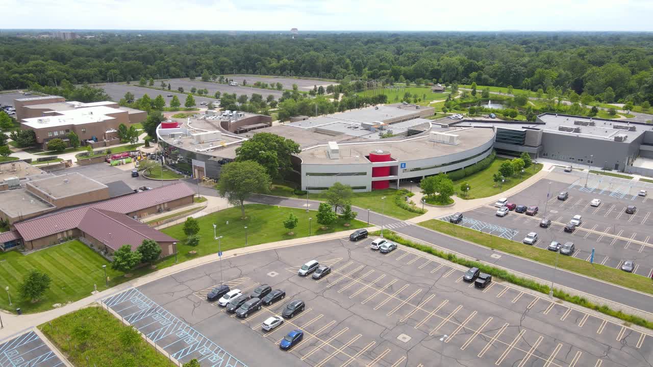 Henry Ford College, Dearborn Michigan, USA with massive parking lot and forest behind