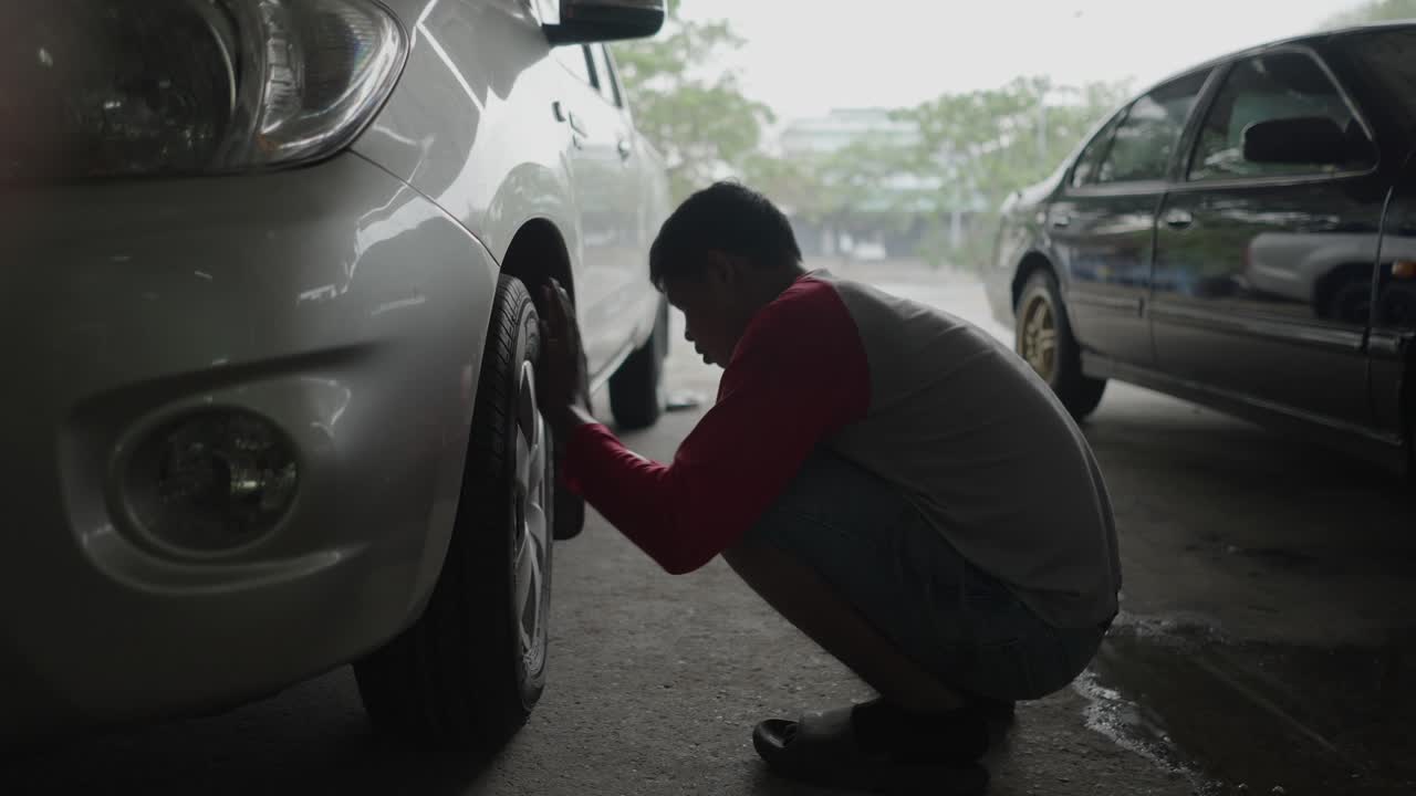 Man cleaning a car tire