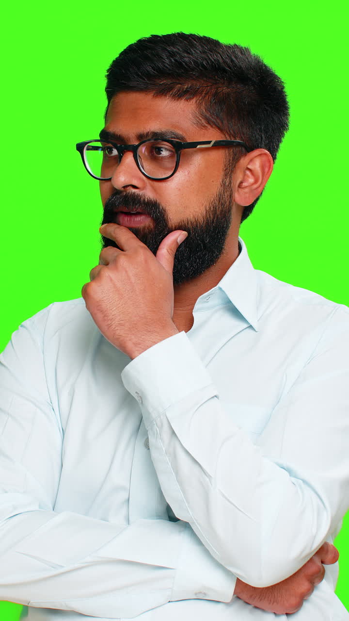 Indian man touching chin with thoughtful face showing idea development thinking process chroma key