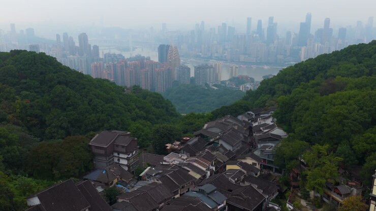 Huangjueya Old Street With The Modern Sprawling Chongqing Skyline In The Distance In China. Aerial Shot