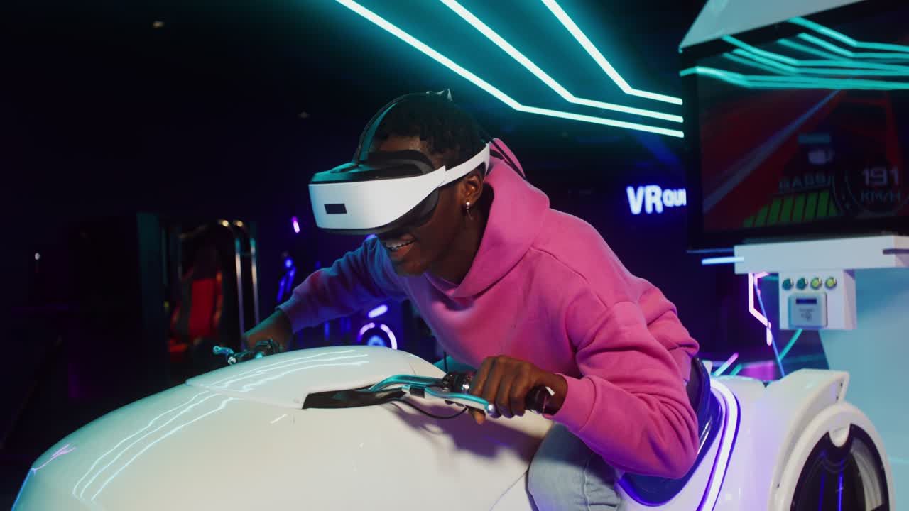 Man plays VR racing game in arcade