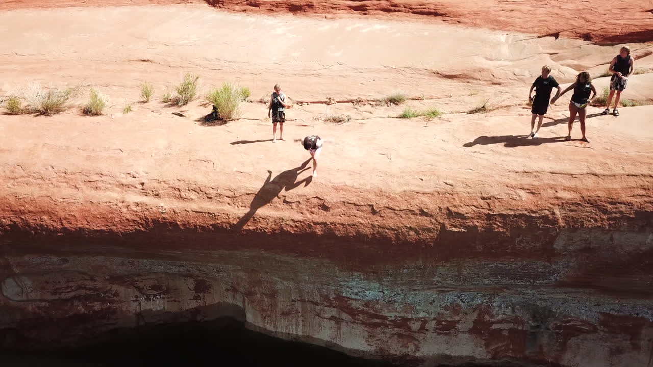 Drone shot of cliff jumper doing trick in Lake Powell Utah