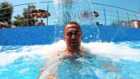 man refreshing on vacation. selfie shot of man in water surface at pool