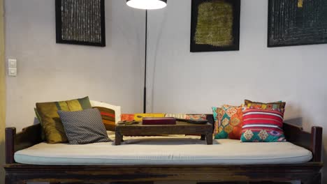 slow descending shot of an antique couch and table in the corner of a villa in nimes