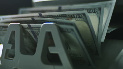 hundred dollar bills in a bill dispenser