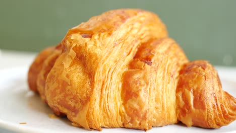 Croissant-Recién-Horneado-En-Un-Plato-Con-Espacio-Para-Copiar-Foto-De-Alta-Calidad