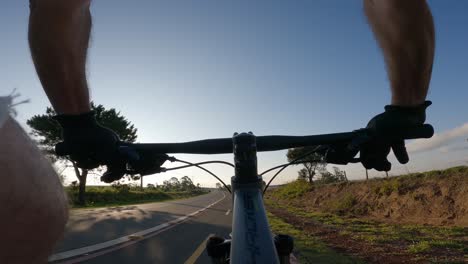 cyclist riding on a cycle lane with signposts, pov shot