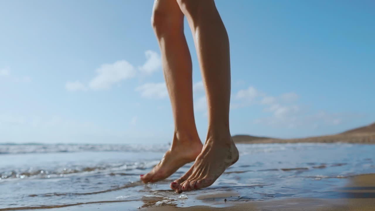 Beautiful girl athlete with beautiful Breasts in black shorts and a white top crouches and makes a jump up. Circular training for the heart. SLOW MOTION STEADICAM