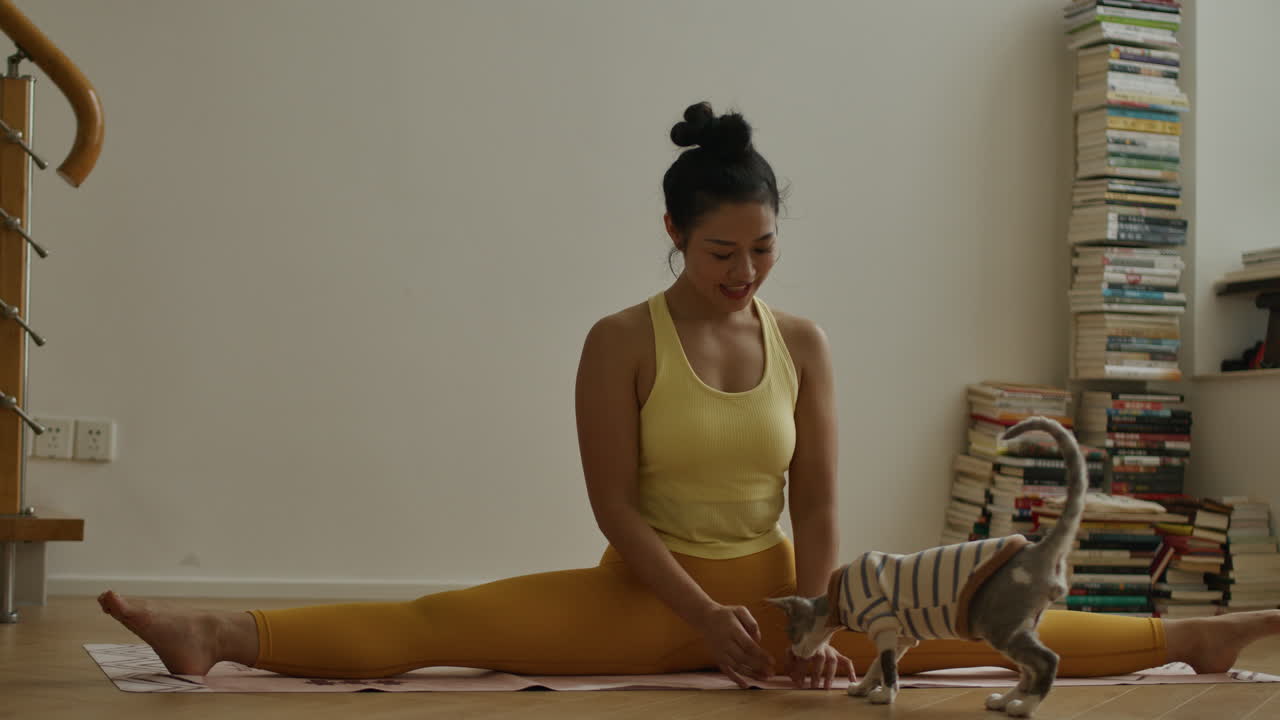 Woman Doing Yoga with Her Cat at Home