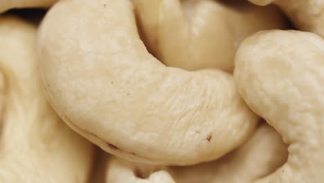 smooth camera movement over a handful of cashew nuts.