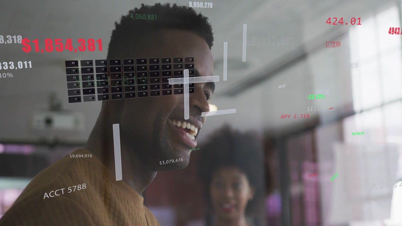 Seeing finance HUD on glass, man turning toward coworker, smiling then laughing as camera shifting